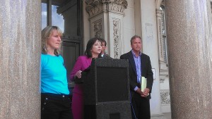 Amy Roe, center, with the Delaware Sierra Club announces the group is suing environmental regulators in Delaware and New Jersey.
