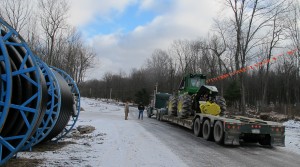 An oversize truck load moves heavy equipment through the Tiadaghton State Forest.