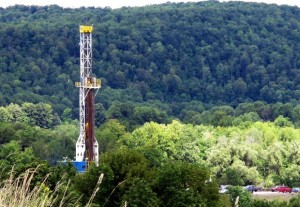 A drill rig rises above the trees in the Tioga State Forest.