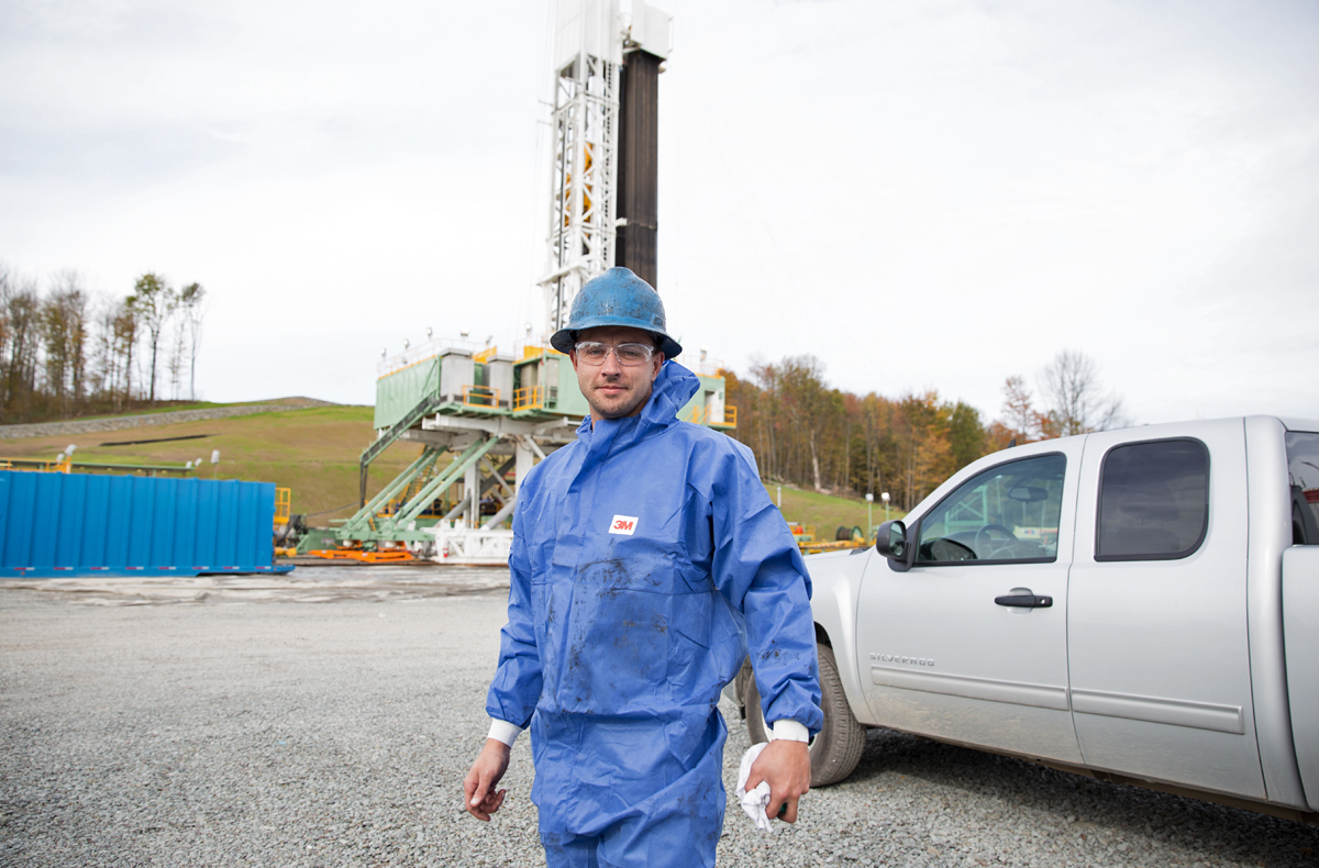Gerald Herb cleans out the dirty tanks at a drill site in Kingsley, Pa