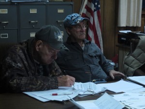 Highland Township supervisors Jim Wolfe, right, and Paul Burton, left, signed an agreement to retain legal counsel to defend the township's ban on deep injection wells. 
