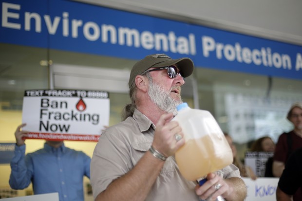 Ray Kemble of Dimock, displays a jug of what he identifies as his contaminated well water in this August 2013 file photo.