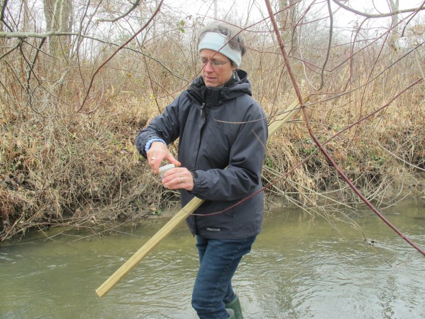 Joanne Martin collects a sample of water from Brady Run, a stream in South Beaver Township in western Pennsylvania. She is a citizen scientist monitoring the water for potential pollution from nearby natural gas drilling.