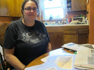 Kim McEvoy sits at the kitchen table in her new home in Butler County. 