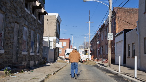 PGW area supervisor Carlos Rojas walks toward a work site where aging gas lines are being updated. Philadelphia plans to replace 1,500 miles of cast-iron pipelines in the city over 88 years.