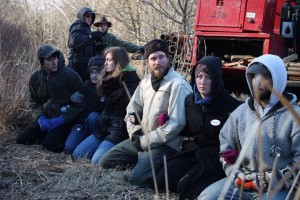 Protestors of the Atlantic Sunrise pipeline link arms before they are arrested by police for trespassing on private property in Conestoga, Pa. 