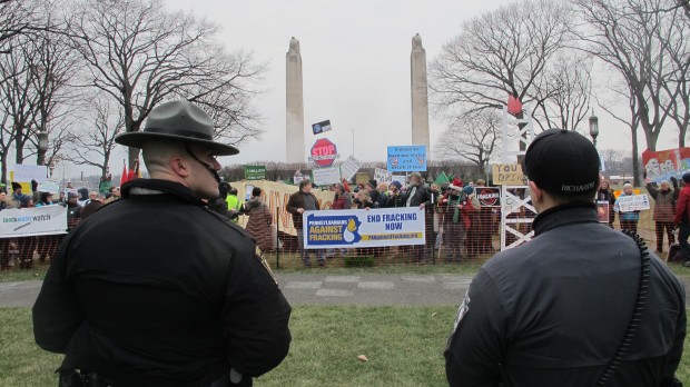 Police monitor an anti-fracking protest at Gov. Wolf's inauguration in January. 