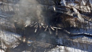 In this aerial photo made available by the Office of the Governor of West Virginia shows a derailed train in Mount Carbon, WV., Tuesday Feb. 17, 2015.  The train carrying crude oil derailed Monday night, causing a large fire that forced hundreds of people to evacuate their homes and temporarily shutting down water treatment facilities. (AP Photo/ Office of the Governor of West Virginia, Steven Wayne Rotsch)