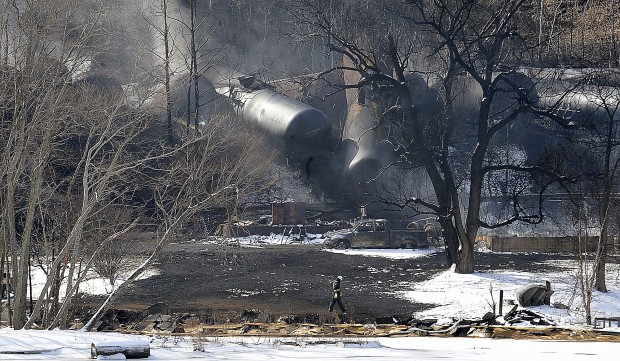 This Feb. 17, 2015 file photo shows a crew member walking near the scene of a train derailment near Mount Carbon, W.Va. 