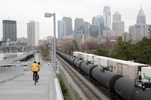Oil trains like this one en route through Philadelphia carried their largest monthly total of crude to East Coast refineries in February, the federal government said.