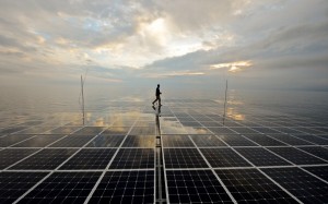 French Erwann Le Rouzic, captain of Planetsolar catamaran, the first boat around the world with solar energy, walks over the photovoltaic panel during his 581st day of sailing around the world, in the Mediterranean Sea near Corsica on May 1, 2012 . 