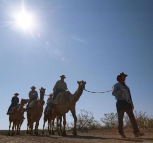Camel riders trek through the Chihahuan desert.