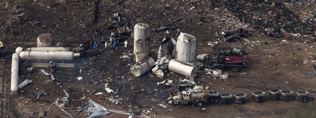 An aerial view shows investigators walking through the aftermath of a massive explosion at a fertilizer plant in the town of West, near Waco, Texas April 18, 2013.
