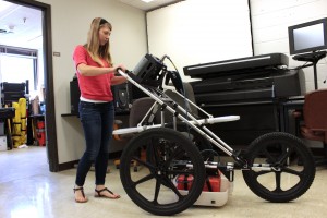 Geology research student Kirstie Haynie at the University of Houston with ground penetrating radar "stroller" 