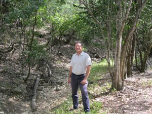 San Marcos resident and community activist Jay Hiebert stands beside Sessom Creek, then dry in the midst of a summer drought. 