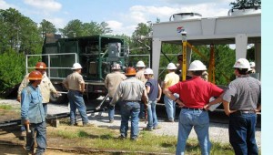 Crew installing geothermal power generator at well site near Laurel, Mississippi.