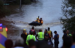 First responders pull flood victims from a flooded South East Austin neighborhood.