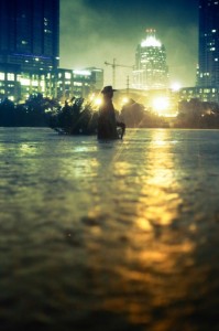 A statue of Stevie Ray Vaughn wait-deep in water, taken the night of the flood.