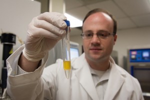 Hal Alper of UT examines a sample of his new yeast-based biofuel. 