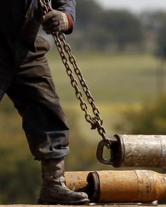 A worker hooks up pipe during drilling in the Barnett Shale near Fort Worth, Texas in 2012. 