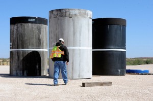 John Ward, operations project task manager at Waste Control Specialists' facility near Andrews, Texas, walks over to inspect concrete canisters that will house drums of nuclear waste.