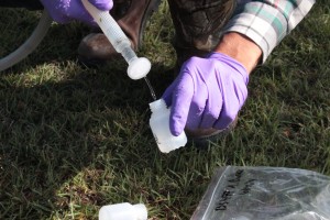 UT-Arlington researcher Zac Hildenbrand captures sample of well water in Denton County