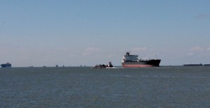 Big freighters and small barges in the Houston Ship Channel.