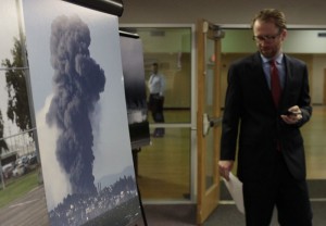 Luke Metzger, Environment Texas, who testified at EPA hearing, passing by a photo of a refinery explosion in California.