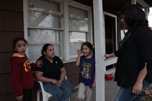 Esmerelda Moreno and her two daughters talk with Belinda Vasquez.