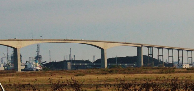 Mountains of petroleum coke near the Beltway 8 bridge at the Houston Ship Channel. 
