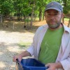 Dustin Green, owner of 10 Acre Woods farm near Norman, feeds a few of his 400 or so chickens.