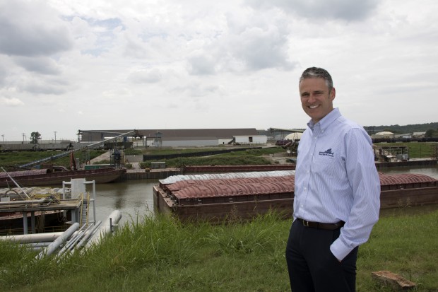 Port of Catoosa Deputy Director David Yarbrough stands at the across the the port's main dock, where a barge is being unloaded.