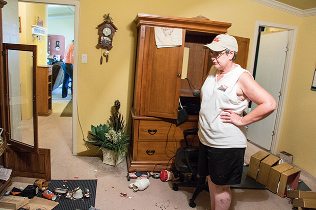 Mona Denney surveys earthquake damage inside her home near Pawnee, Okla.