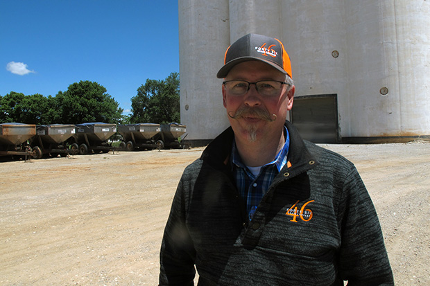 J.D. Drennan, senior agronomist for 46 Grain Company, stands in front of the grain elevator at Farmers' Elevator Company in Ames, Oklahoma. 