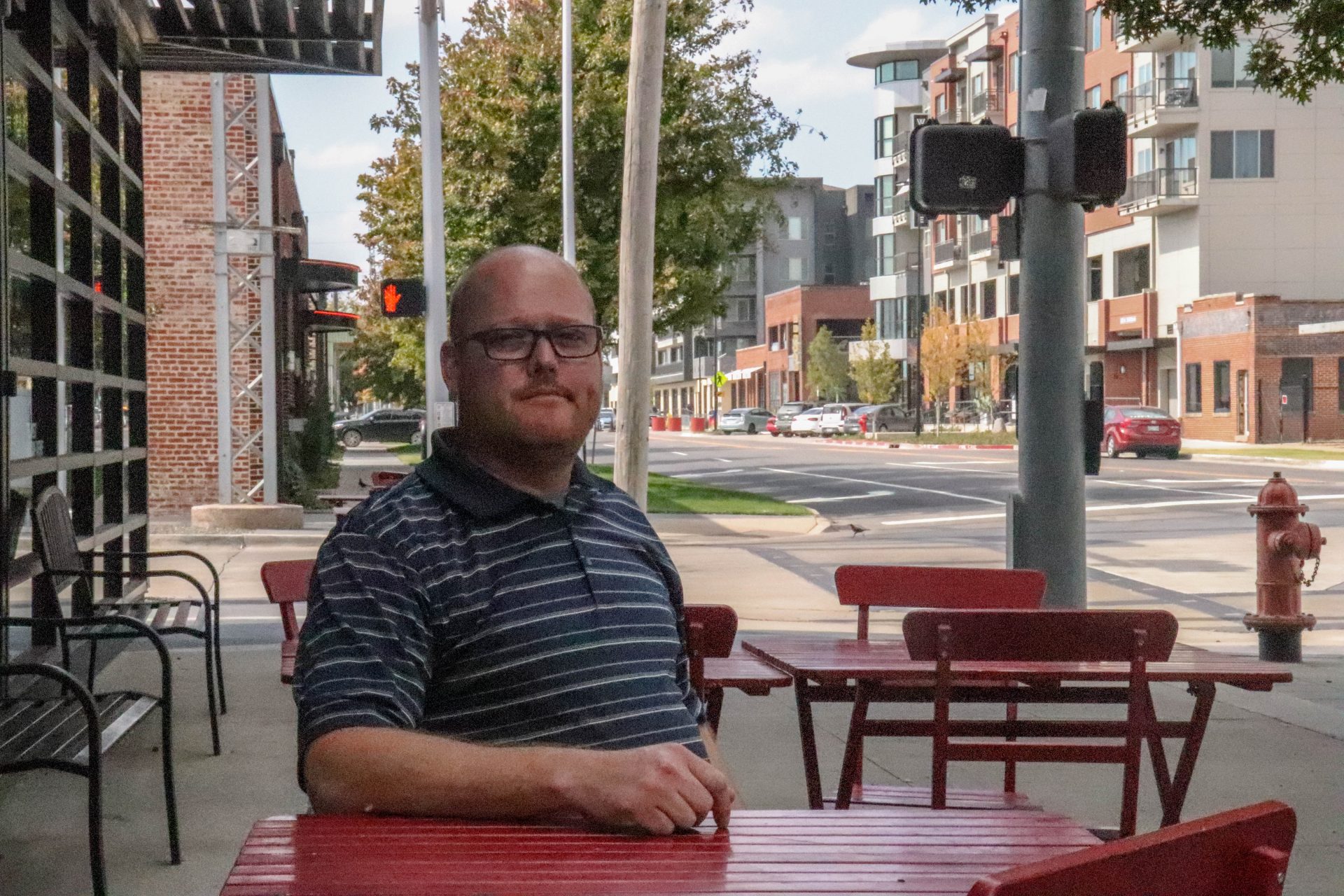 Jason Hanan sits at a red table in downtown Oklahoma City.