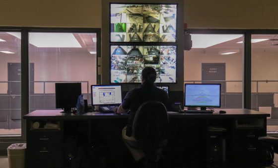 A Canadian County employee keeps watch in the control room of the county jail.