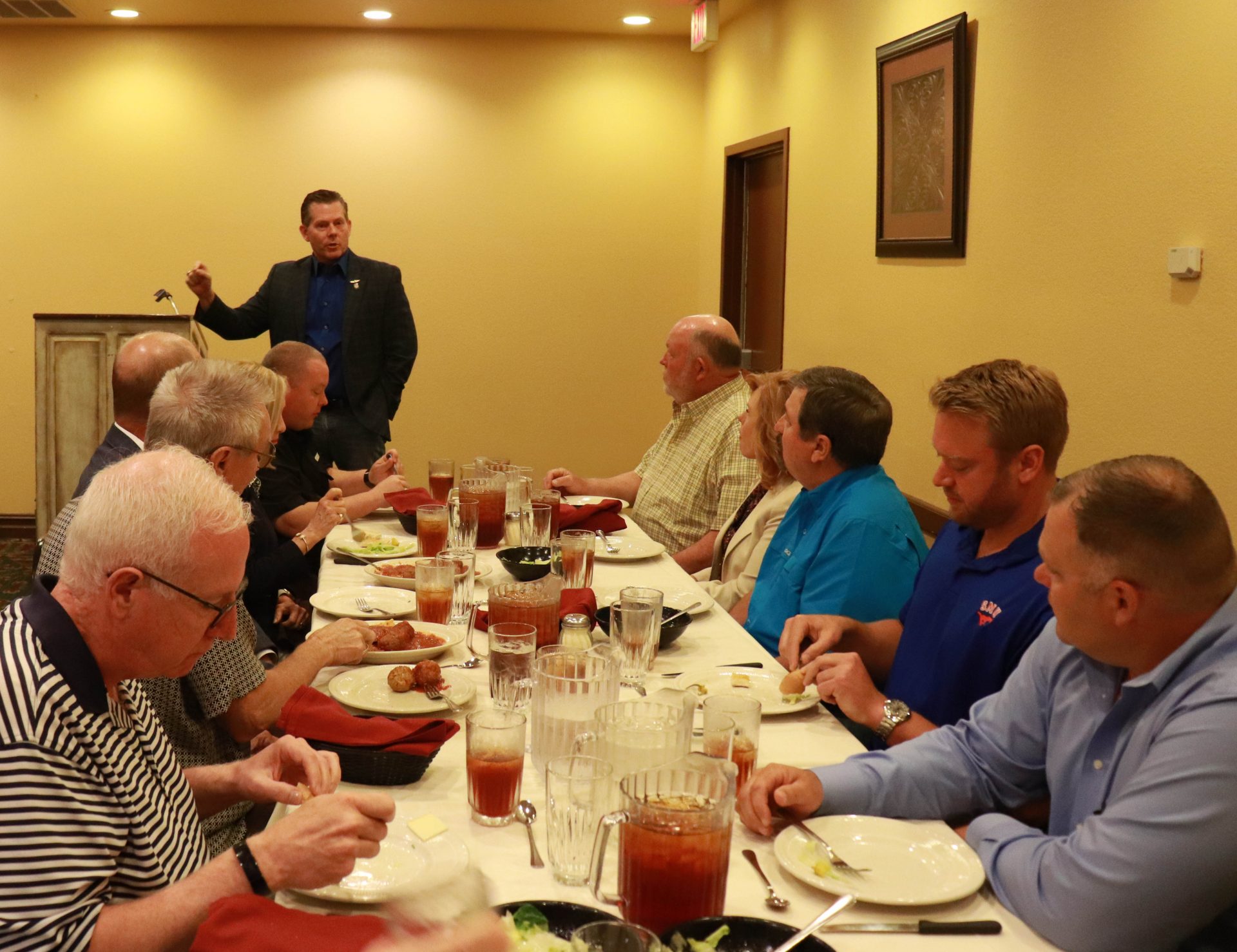 Rep. Kevin McDugle speaks to a group of legislators sitting down for lunch inside Pete's Place.