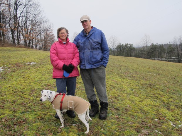 Marianne and Rick Atkinson with their dog Spot, on their property in Clearfield County.