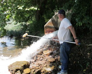 Ken Dufalla samples water at the Clyde Mine discharge along Ten Mile Creek in July, 2015. 