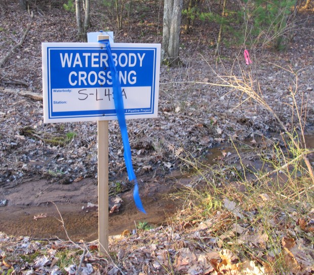A sign marks a water crossing on land in Huntingdon County where Sunoco wants to build the Mariner East 2 pipeline. Although Sunoco still has to acquire water crossing and earth moving permits, the company has already cleared the area of trees.