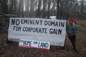 .Megan Holleran stands by a sign on her family's land. The Hollerans lost their court battle to save their maple trees from eminent domain seizure. The trees are being cut to make way for the new Constitution Pipeline.