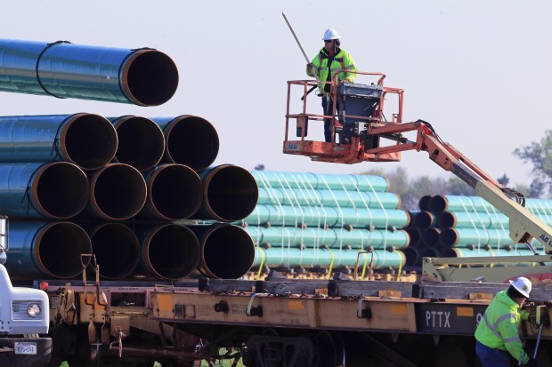 Workers unload pipes at a staging area in Worthing, S.D., for the proposed 1,130-mile Dakota Access Pipeline that would stretch from the Bakken oil fields in North Dakota through South Dakota and Iowa to a hub in Illinois.