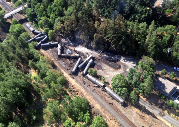 This aerial view provided by the Washington state Department of Ecology scattered and burned oil tank cars shows Saturday, June 4, 2016, after the train derailed and burned near Mosier, Ore., Friday. Union Pacific Railroad says it had recently inspected the section of track near Mosier, about 70 miles east of Portland, and had been inspected at least six times since March 21. 