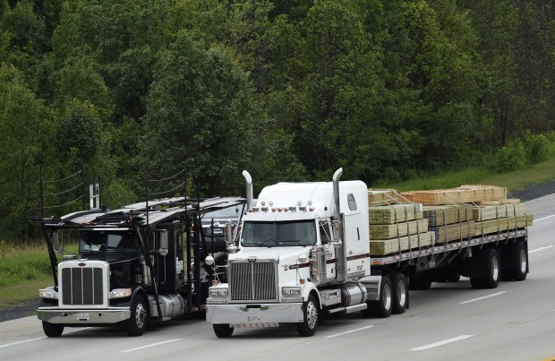 Trucks head eastbound on Rt 50 in Bowie, Md., Friday, June 19, 2015. The Obama administration on Tuesday unveiled tougher mileage standards for medium and heavy-duty trucks, the latest move by President Barack Obama in his second-term drive to reduce pollution blamed for global warming. 