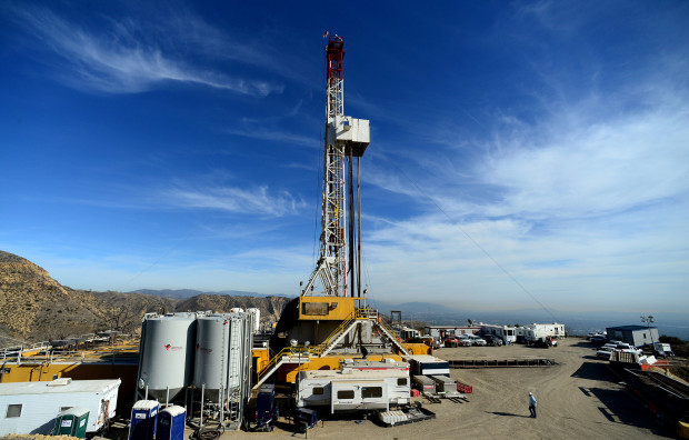 In this Dec. 9, 2015, file photo, crews work on stopping a gas leak at a relief well at the Aliso Canyon facility above the Porter Ranch area of Los Angeles. 