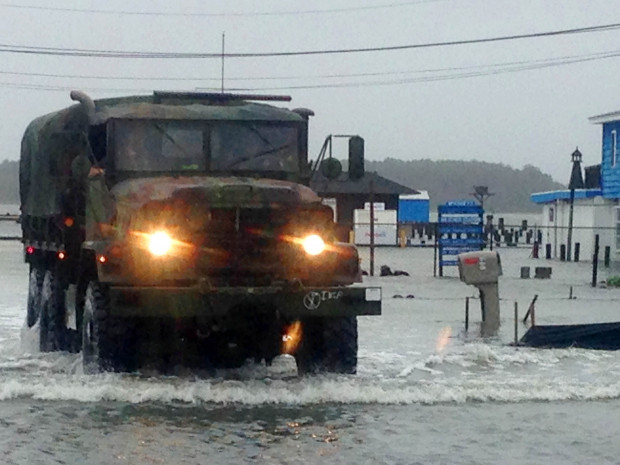 Police patrol flooded streets in a military vehicle in Dewey Beach, Del., on Saturday, Oct. 3, 2015. Tidal flooding from a nor'easter continues to make driving a challenge in the storm-battered resort town of Ocean City, Maryland.