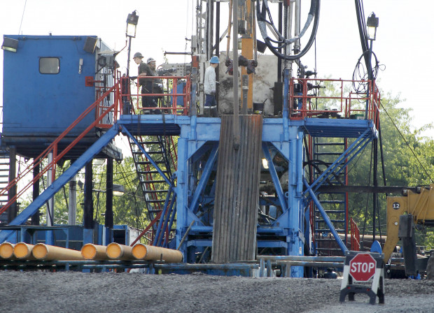 A crew works on a drilling rig in Zelienople, Pa. file photo