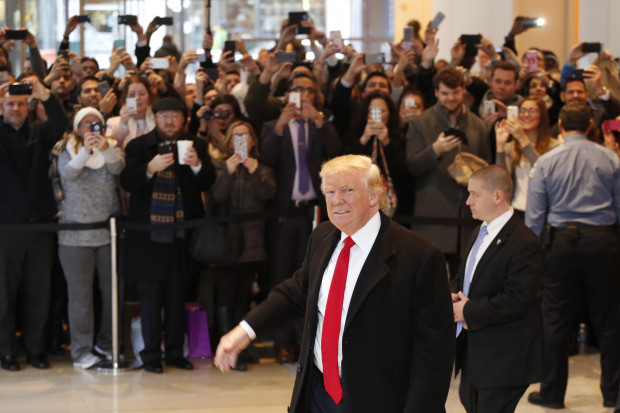 President-elect Donald Trump walks past a crowd as he leaves the New York Times building following a meeting, Tuesday, Nov. 22, 2016, in New York. 
