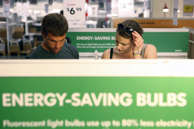 Philadelphia has launched a program to improve the energy efficiency of low-income residences, as well as small businesses in the city. In this file photo, Joe Mozloom and Allison Roethke shop for compact fluorescent bulbs at an Ikea store in Philadelphia, June 15, 2010.