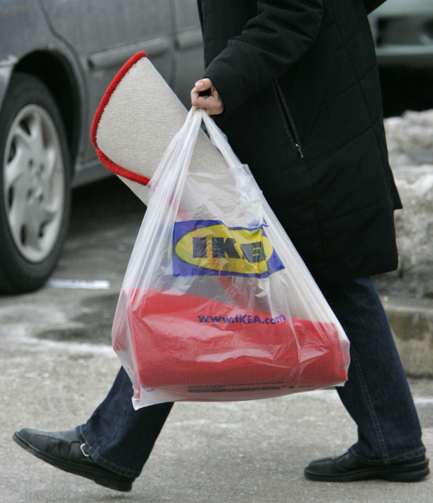 A customer totes a shopping bag outside an Ikea store in Conshohocken, Pa., on Tuesday, Feb. 20, 2007. The Swedish retailer, which has its U.S. headquarters in suburban Conshohocken, announced Tuesday that it will start charging customers a nickel for 